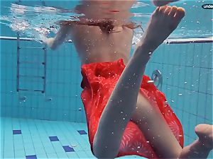 red clothed nubile swimming with her eyes opened